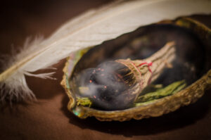 A picture of burning sage inside a beautiful shell